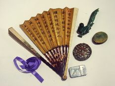 An oriental fan, carved stone jade type bird, magnifying glass, ribbands, etc., together with a