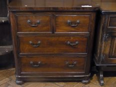 An old mahogany chest of two short and two long graduated drawers on bun feet, width 88cm