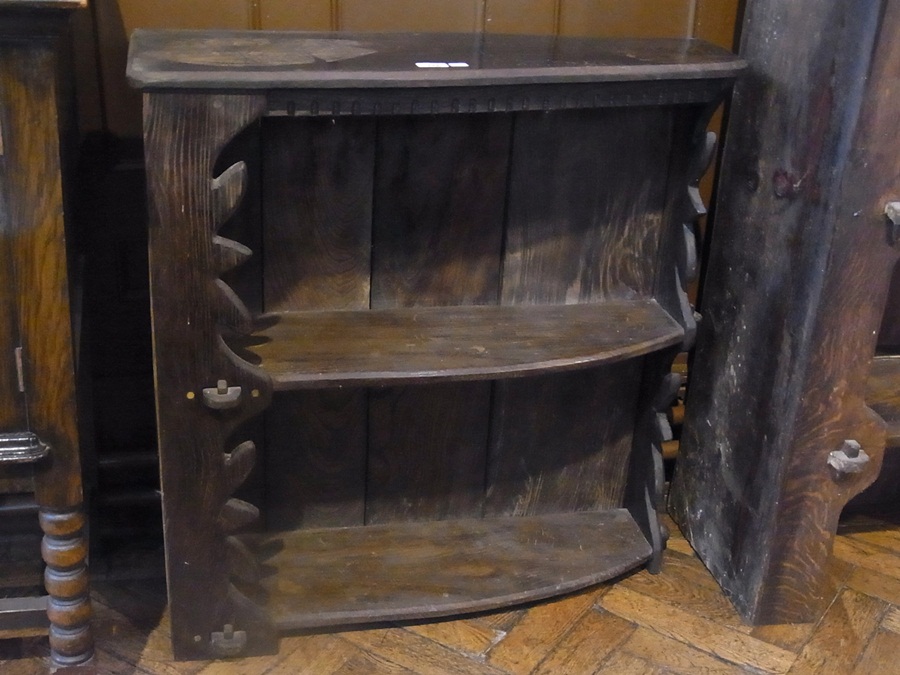 A rustic style oak open bookcase with two shelves, with carved supports, width 82cm