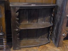 A rustic style oak open bookcase with two shelves, with carved supports, width 82cm