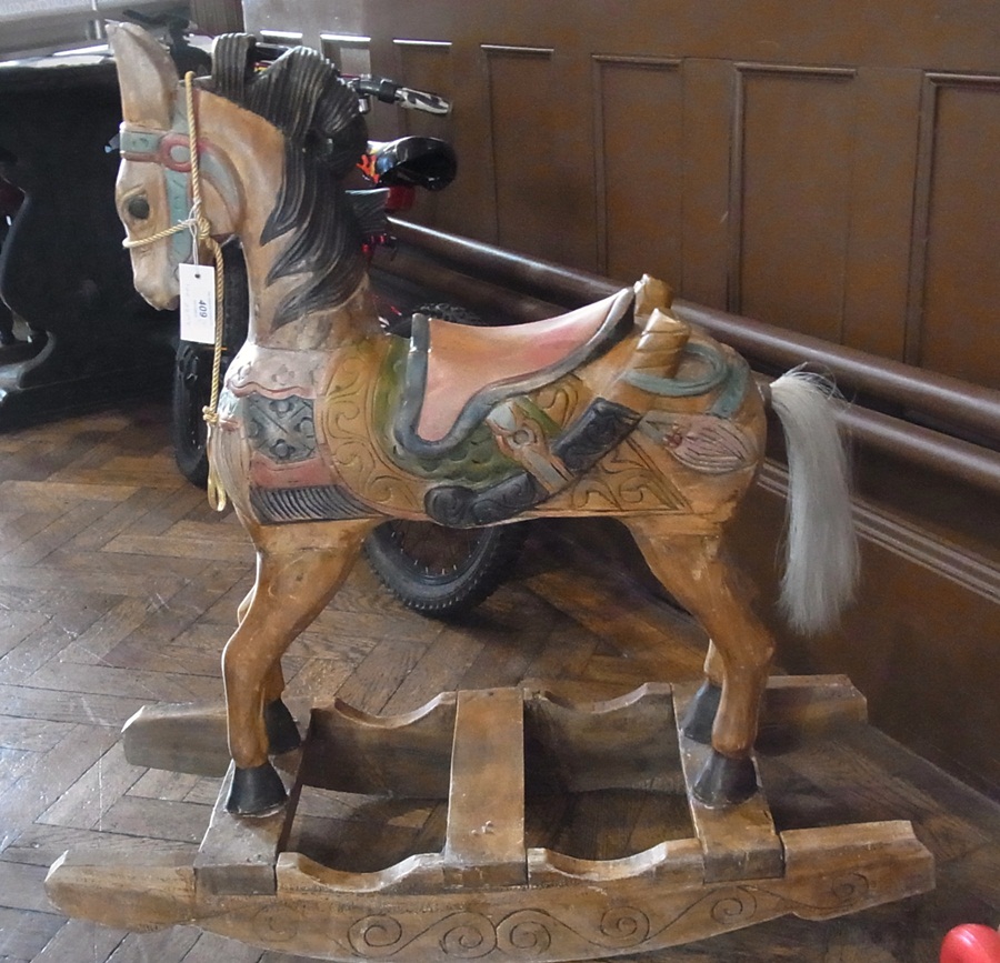 A Eastern painted and carved wooden rocking horse, 82cm tall together with a child's push-along