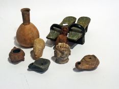 A quantity of antique stone and pottery items, a clay pipe Negro head and a pair of Eastern-style