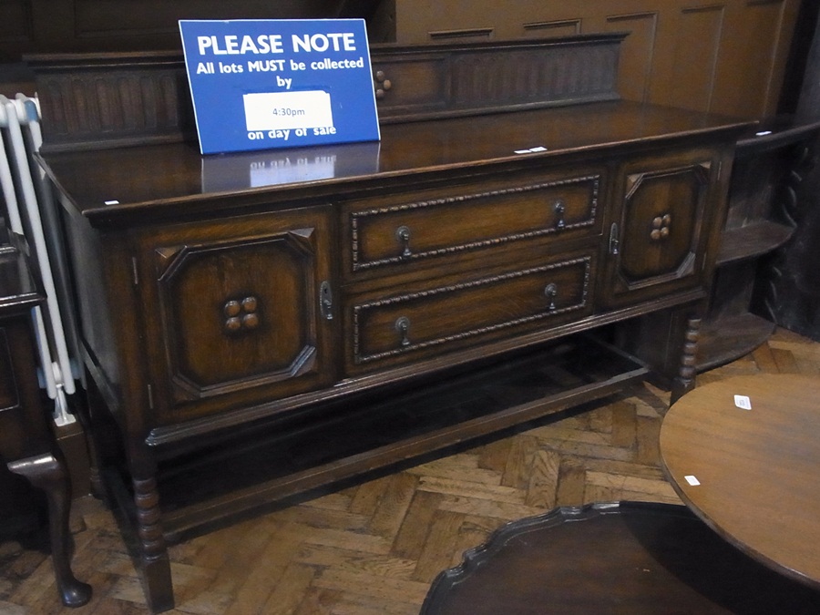 A twentieth century Jacobean style sideboard with two central drawers flanked by moulded front