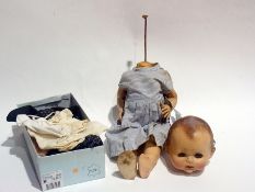 A Pedigree plastic baby doll and a quantity of clothing (1 box)