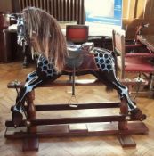 A large reproduction Victorian rocking horse on pedestal stand, black and dapple painted complete