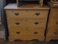 A pine chest of three long drawers with brass handles, on bracket style feet, 80cm wide