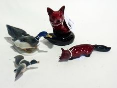 Royal Doulton flambe figure of seated fox and another of crouching fox, Rosenthal model of two ducks