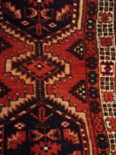 Persian style wool runner, red ground with blue and green lozenge, 92cm x 180cm