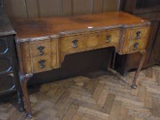 A twentieth century Queen Anne's style burr walnut kneehole writing table with inset writing top,