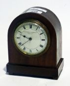 A mahogany domed cased mantel clock with enamel dial, with brass drum movement raised on brass bun