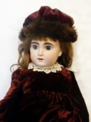 A 19th century French bisque-head impressed "10" doll, possibly Jumeau, having blue paperweight