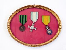 Three 19th century French medals in oval frame, Franco-Prussian service medal, silver cross of