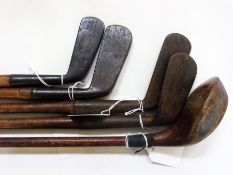 Four hickory shafted putter golf clubs by Mitchell & Co (Manchester), Hamleys (London), F Forgan &