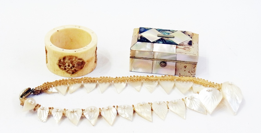 A Chinese ivory napkin ring, carved with scenes, a mother-of-pearl trinket box (af) and a mother-
