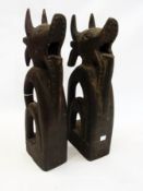 Set of four African cow carvings each of a horned cow with open mouth, open scroll legs, on plinth