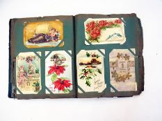 Early 20th century greetings cards and postcards two albums (2)   Condition Report  Please contact