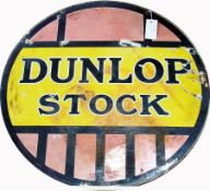 Tinplate "Dunlop Stock" circular sign in yellow, black and pale red, 61cm diameter, some damage