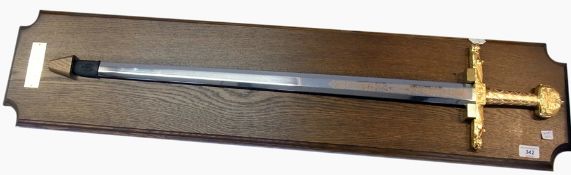 Reproduction sword of Charlemagne mounted on oak plinth    Condition Report  Please contact the