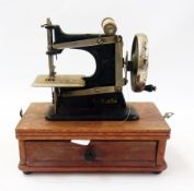 "Baby" sewing machine in oak case, with drawer    Condition Report  Please contact the Auctioneer