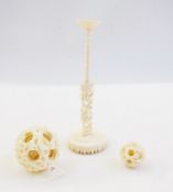 Oriental carved ivory puzzle ball on stand, the ball dragon decorated on pierced stand and another