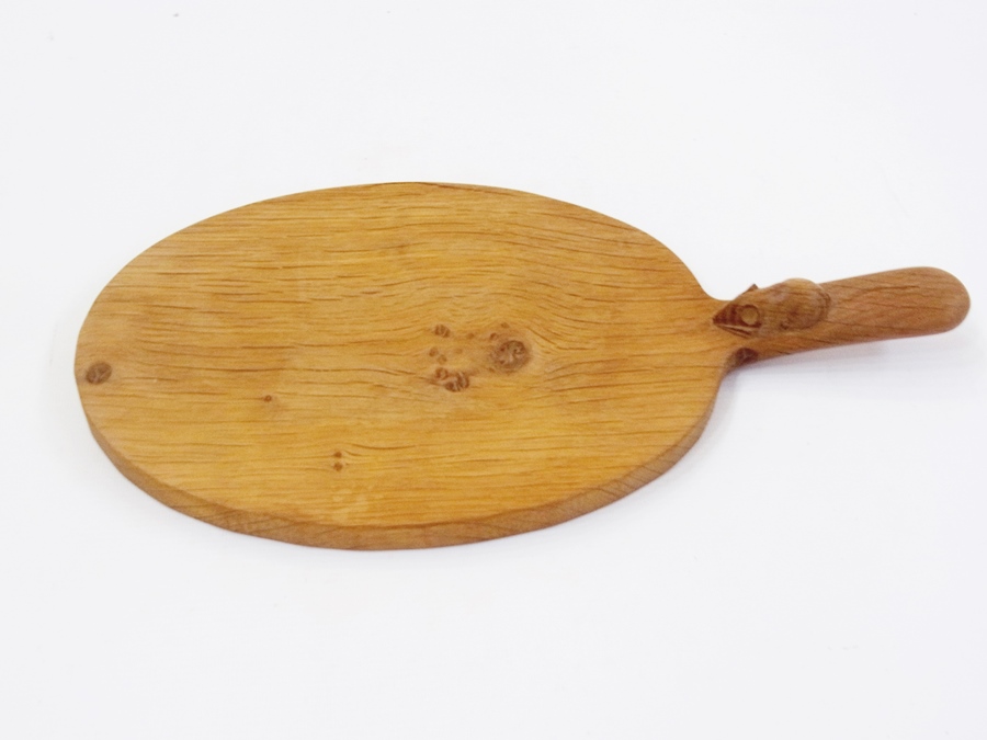A Mouseman carved wood cheese board, oval with mouse to handle    Condition Report  Please contact