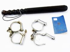 A wooden truncheon, two pairs of handcuffs and a "Police Forces Active Service Edition Prayer