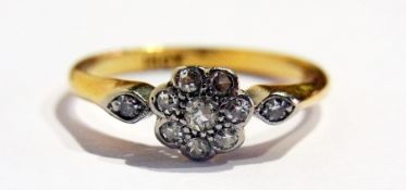 18ct gold diamond flowerhead ring with two small diamonds to the shoulders