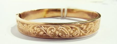 A 9ct gold foliate scroll engraved bangle, 10.3g approx.