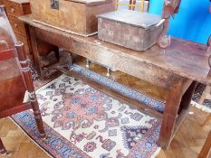 An 18th century French country refectory table, with plain frieze, on square legs, united by central