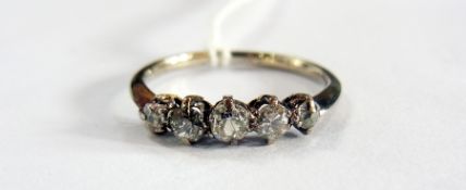 White metal and five stone diamond ring, with five graduated old cut stones