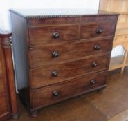 A large Victorian mahogany chest of two short and three long drawers, with turned handles, on bun