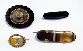 A Victorian mourning brooch, probably jet, another jet-coloured brooch, agate and silver metal