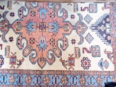 Wool rug of ivory ground with central pink medallion, and light-blue and pink borders, and a