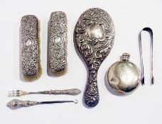 A silver-backed dressing table set, comprising hand mirror and a pair of clothes brushes, together