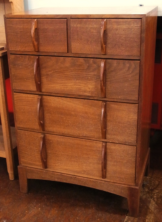 An oak chest of two short and three long drawers by Kenneth Desmond Lampard, Cotswold School, with