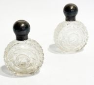 Pair of cut glass circular scent bottles with silver knob tops, hm London 1869