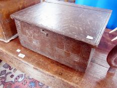 An antique oak workbox, with hinged lid and carved panelled front, 44cm wide
