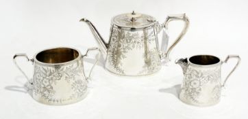 A late Victorian silver plate three-piece tea set of oval form, with foliate engraving, comprising