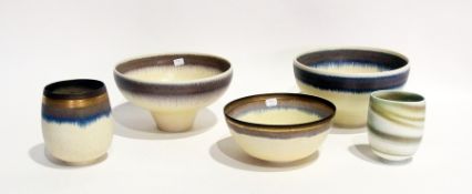 A quantity of studio pottery to include:- three bowls with green glaze and purple borders, a similar