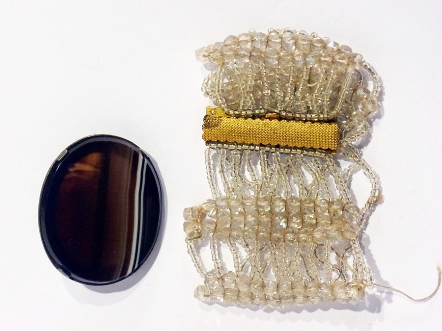A crystal-type bead multi-strand bracelet and a white metal mounted agate brooch