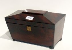 A mahogany tea caddy, sarcophagus shape, on round bun feet, lid damaged rear left hand corner, brass