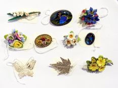 A quantity of floral brooches, two butterfly ring set brooches, a silver filigree butterfly brooch