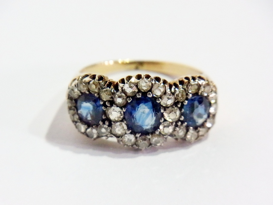 Gold, sapphire and diamond triple-cluster ring set three oval sapphires surrounded by multiple