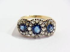Gold, sapphire and diamond triple-cluster ring set three oval sapphires surrounded by multiple
