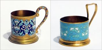 A Russian gilt metal and enamel tea glass holder together with another (2)