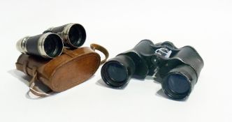 A pair of small field glasses, red morocco leather bound with chrome mounts and having shaped eye