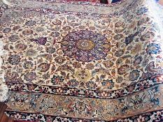 Persian-style wool rug with blue arabesque flowerhead pattern, on a cream ground with allover