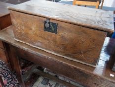 An antique oak box, with hinged lid, carved to front "1781", 76cm wide