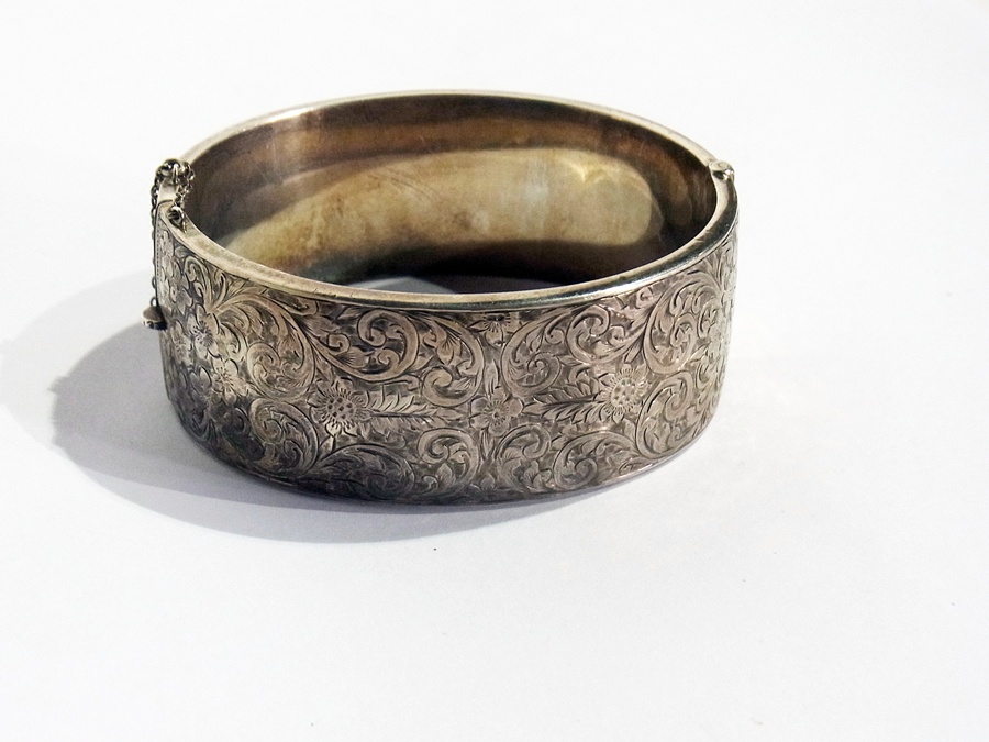 A silver bangle, foliate engraved