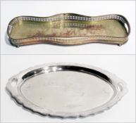 A silver plate butler's tray, with gadrooned wavy border, paw feet and an oval silver plate tray